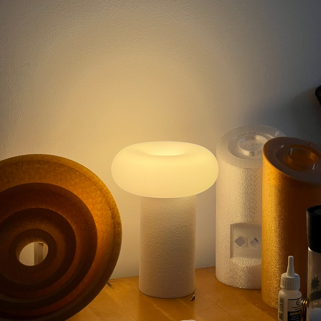 Small lamp on a surface with a textured wall in the background